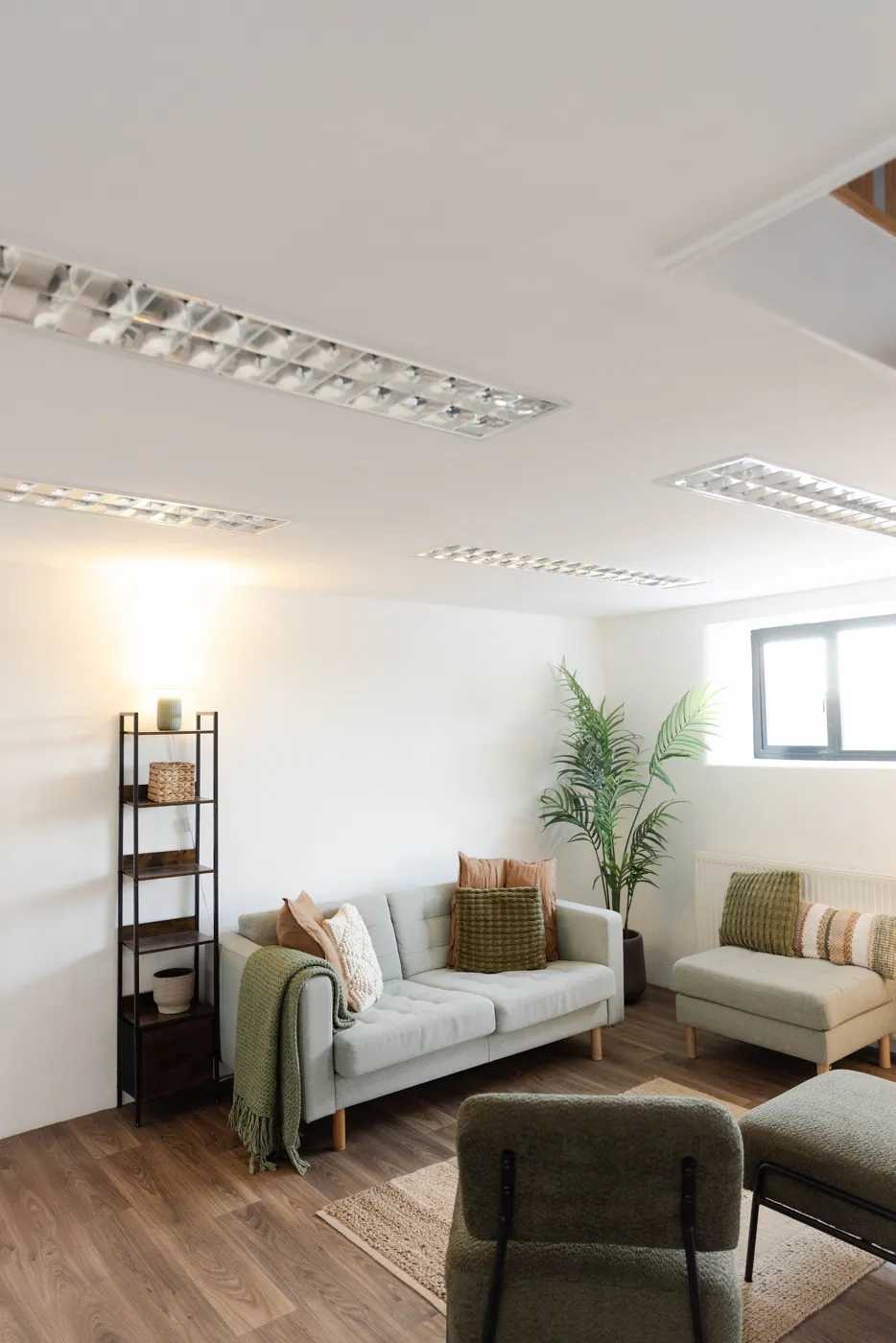 The waiting area at Twelve08, with sofas, plants and a rug